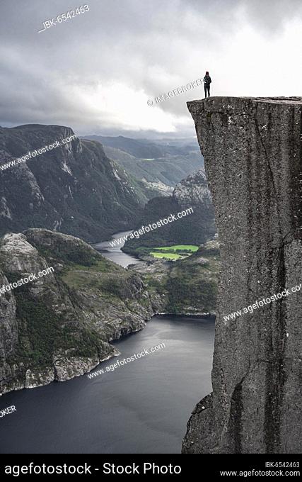 Single person on rock plateau, Preikestolen rock spire, Lysefjord, Ryfylke, Rogaland, Norway, Europe