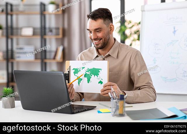 teacher with world map having online class at home