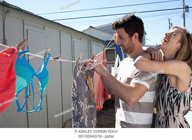 Couple hanging out swimwear, Breezy Point, Queens, New York, USA