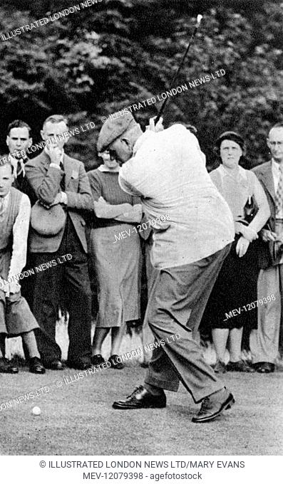 A black and white photo of golfer James Braid winding up a back swing for a No.5 shot, a crowd of men and women behind him watching