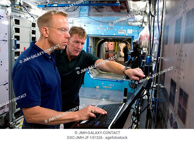 NASA astronaut Tim Kopra (foreground), Expedition 46 flight engineer and Expedition 47 commander; and European Space Agency astronaut Timothy Peake