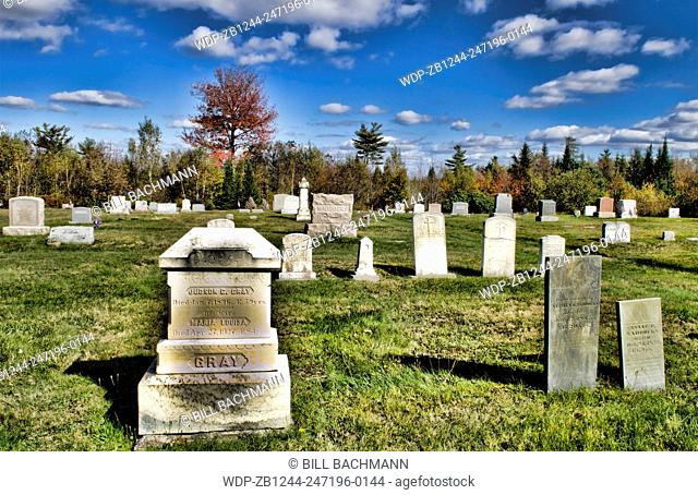 Ellsworth Maine graveyard with tombstones with beautiful fall colors in Northern New England in fall colors foliage in October