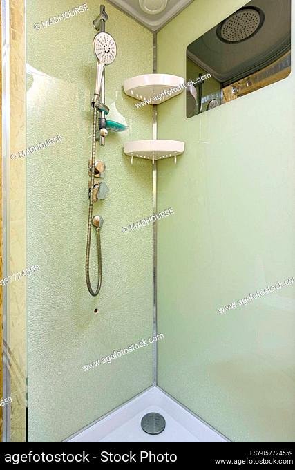 At the back wall of the shower stall on which the mixer and shower are located the glass cracked