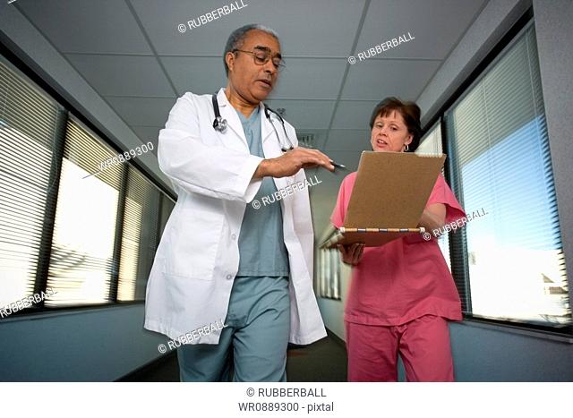 Low angle view of a female doctor and a male doctor discussing