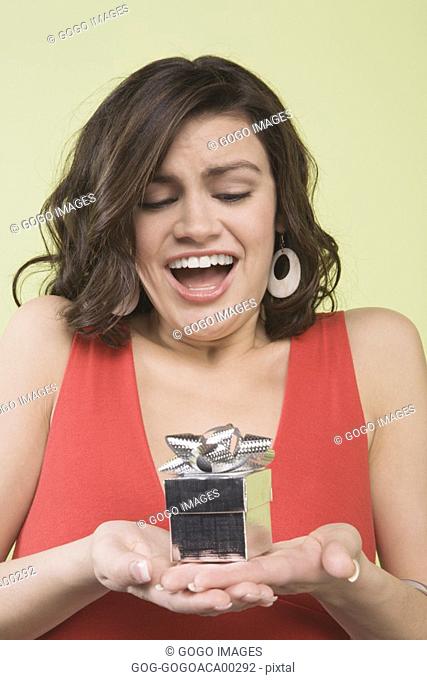 Teenage girl gasping at gift