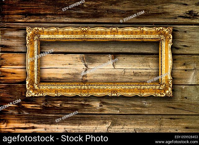 Big Old Gold Picture Frame on wooden background