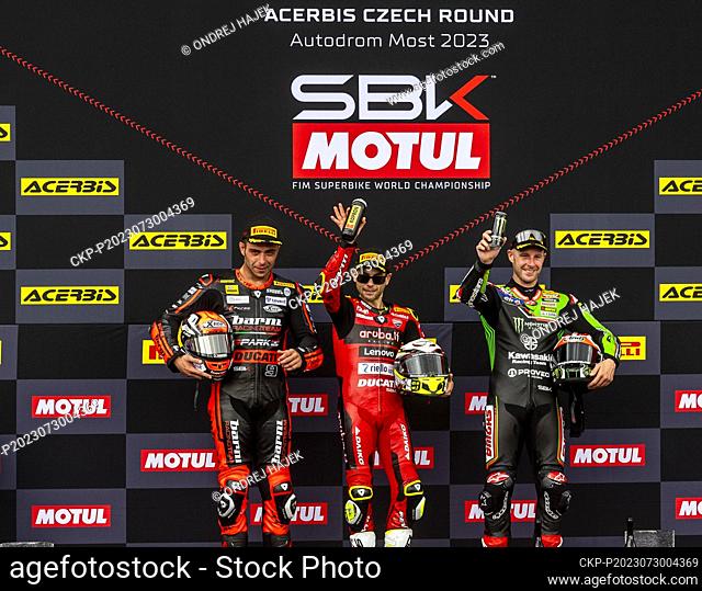 L-R second Danilo Petrucci from Italy, first Alvaro Bautista from Spain and third Jonathan Rea from Britain celebrate on the podium after Race 2 during the 2023...