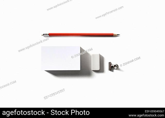 Blank white business card, pencil and eraser. Top view. Flat lay