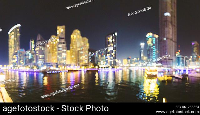 Night Skyline Abstract Boke Bokeh Background. Design Backdrop. Beautiful Night view of high-rise buildings of residential district in Dubai Marina And Tourist...