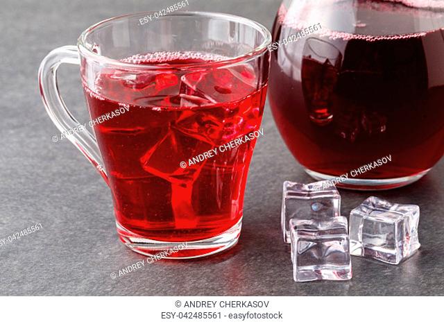 glasses of cranberry cocktail on a black stone with ice