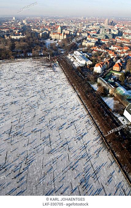 Aerial view of frozen lake Maschsee, New Town Hall and city of Hannover in the winter snow, Lower Saxony, Germany