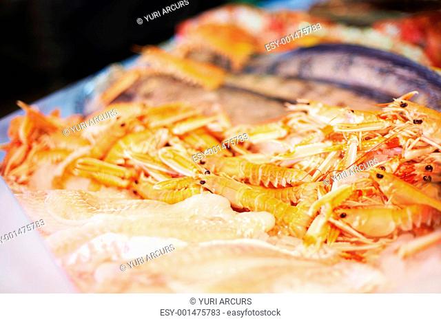 Closeup of a platter of raw prawns and fish