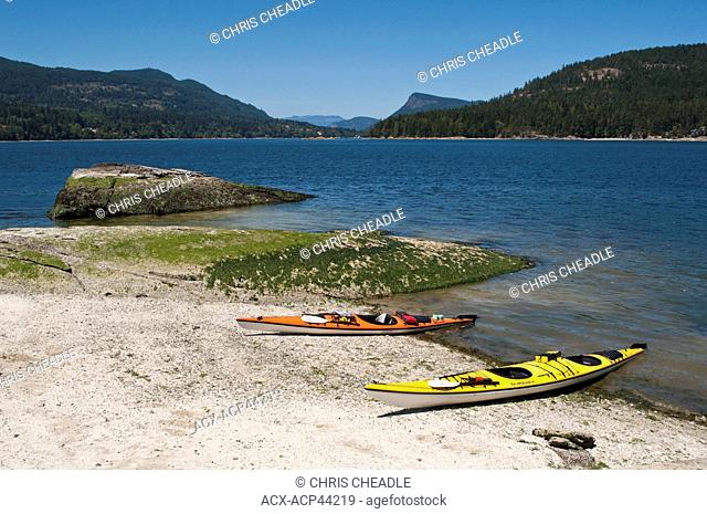 Kayaks on Russell Island with view to Fulford Harbour, Saltspring Island, British Columbia, Canada