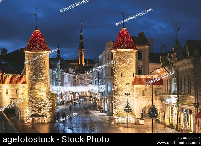 Tallinn, Estonia. Famous Landmark Viru Gate In Street Lighting At Evening Or Night Illumination. Towers In Christmas Holidays Decorations