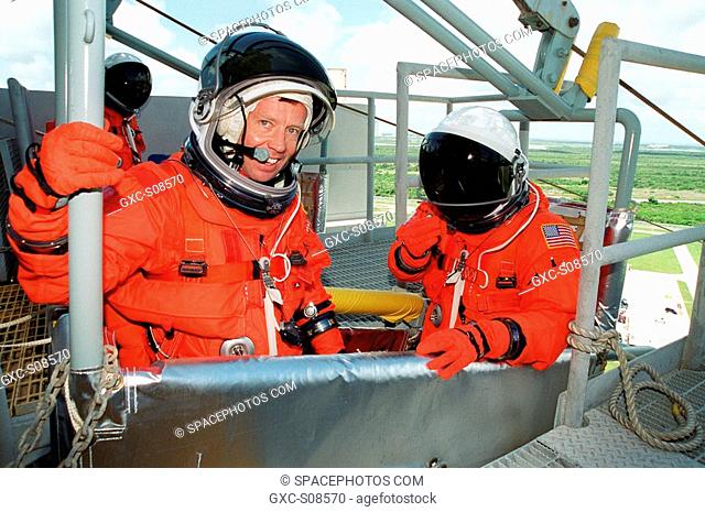 06/29/2001 -- On Launch Pad 39B, STS-104 Commander Steven W. Lindsey left smiles after completing emergency egress training in the slidewire basket he is in