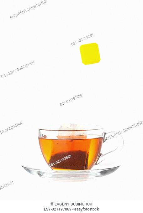 Hot tea in transparent glass cup with label