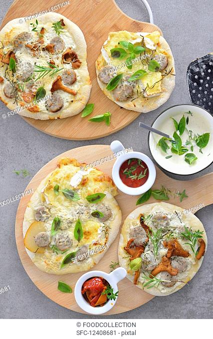 Mini pizzas with mushrooms pear basil white sausage served with tomato sauce