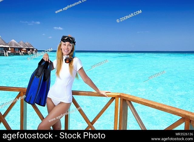 Young pretty woman with flippers, mask and tube. Maldives