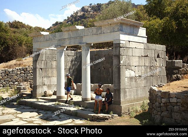 Tourists walking around The Fountain Building at the archaeological site of ancient Kaunos city , Dalyan, Mugla Province, Aegean Region, Turkey, Europe