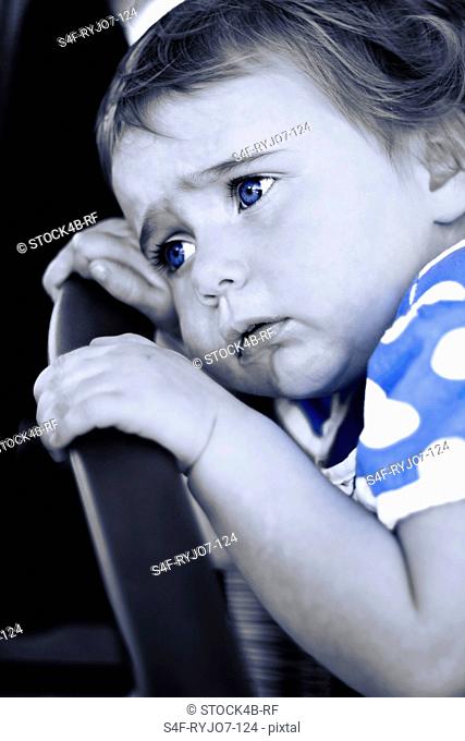Sad toddler with blue eyes