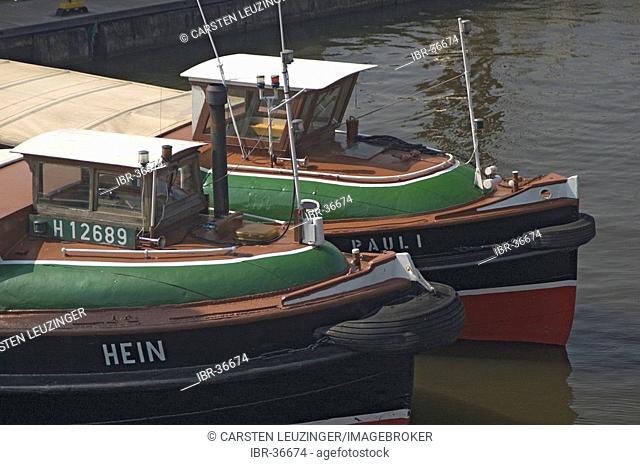 Two small trip boats ar lying side by side at Hamburg Harbour Germany