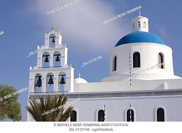Blue domed Greek Orthodox church with steeple and bells in Oia Santorini Greece