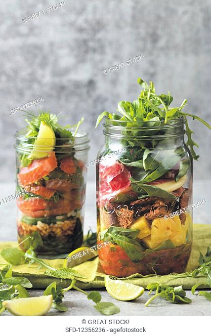 Layered salad in two glass jars