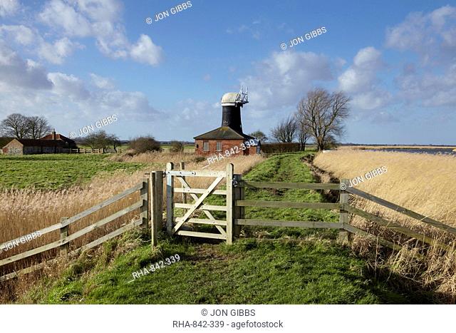 A bright winter day in the Norfolk Broads showing Tall Mill near Upton, Norfolk, England, United Kingdom, Europe