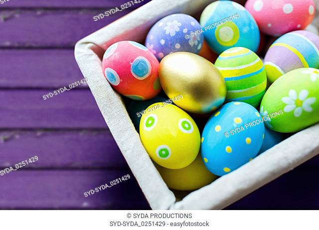 close up of colored easter eggs in basket
