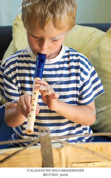 Little boy playing recorder