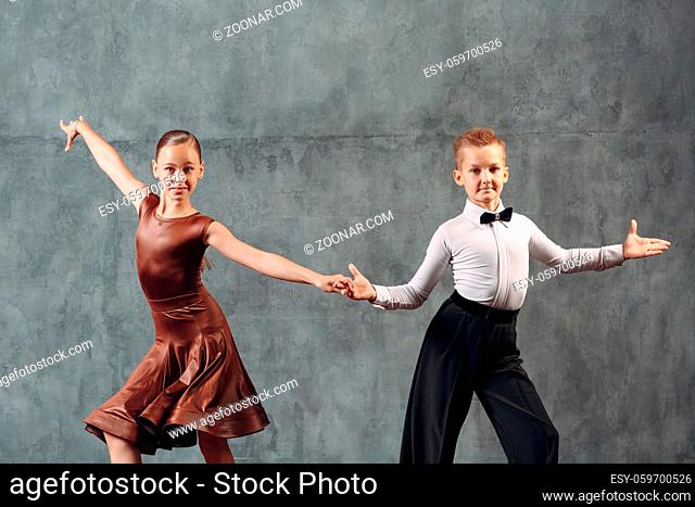 Young couple boy and girl dancing in ballroom dance Samba