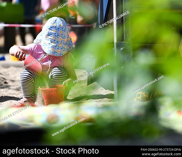 02 June 2020, Hessen, Offenbach/Main: A girl from the nursery group ""Raupe Nimmersatt"" plays on the playground of the day care centre at the Sana Klinikum in...