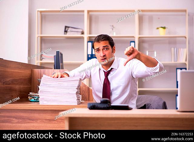 Young employee extremely tired with excessive work