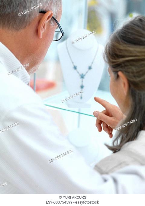 Closeup of older couple shopping for jewelery