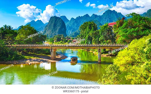 Amazing landscape of Nam Song river among mountains. Bridge on the foreground. Pha Tang, Vang Vieng district, Laos. Panorama