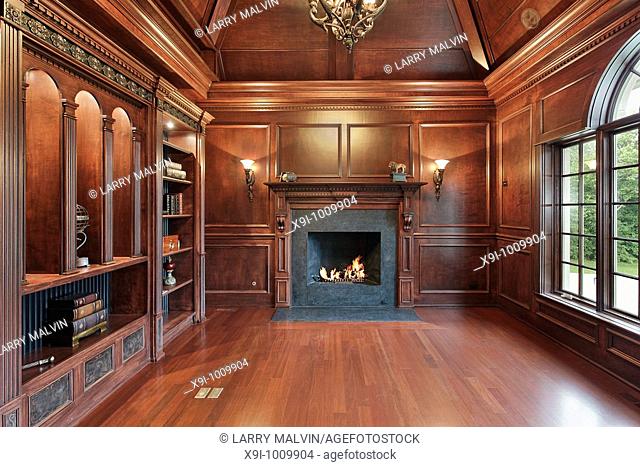 Elegant library in luxury home with black marble fireplace