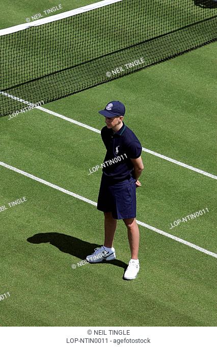 England, London, Wimbledon, A ball boy stands by the net during the Wimbledon Tennis Championships 2008