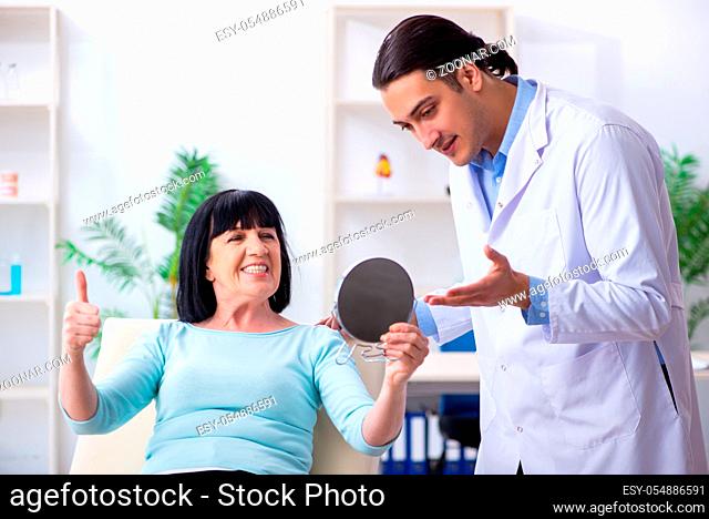 The old woman visiting young doctor dentist