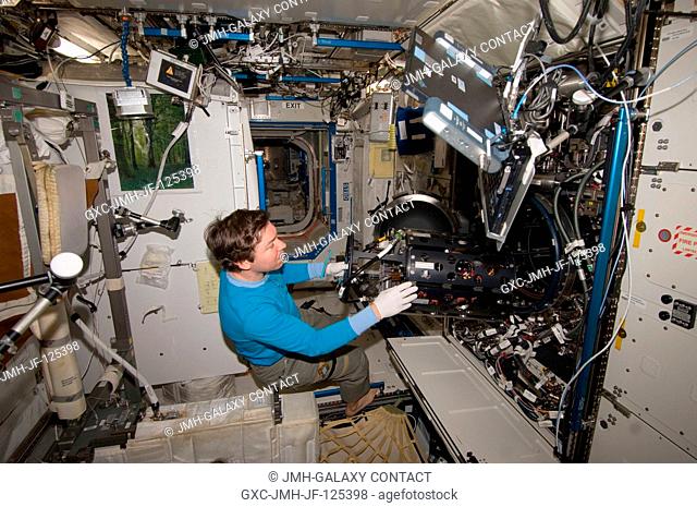 NASA astronaut Michael Barratt, Expedition 20 flight engineer, works with the Multi-user Droplet Combustion Apparatus Chamber Insert Assembly (MDCA CIA) in the...
