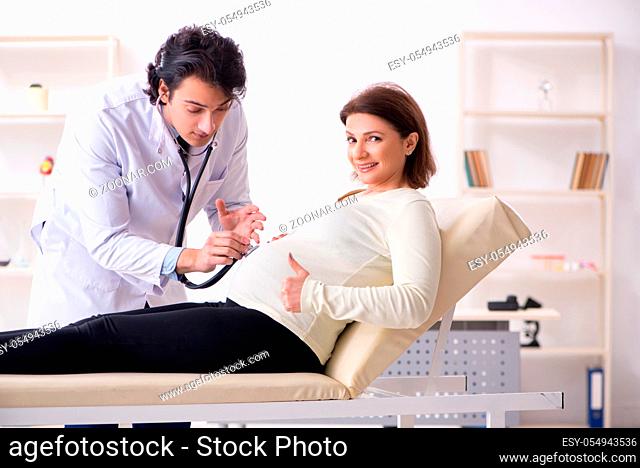 Old pregnant woman visiting young male doctor