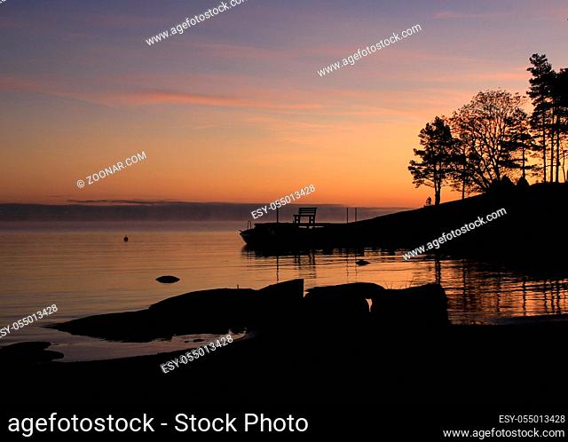 Bright orange morning sky and shore of Lake Vanern, Sweden