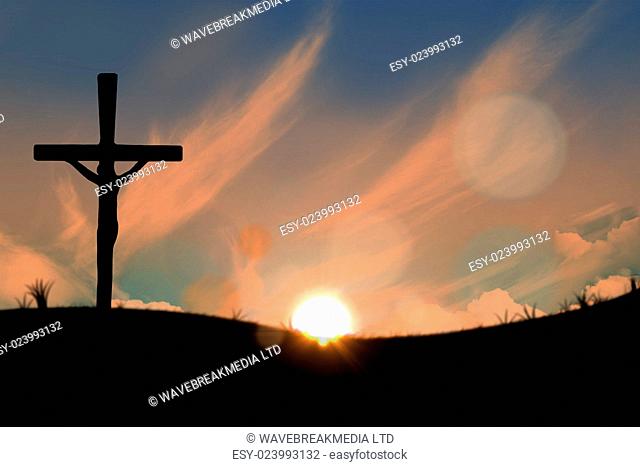 Cross religion symbol shape over sunset sky