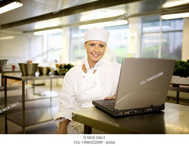 A chef working at her laptop