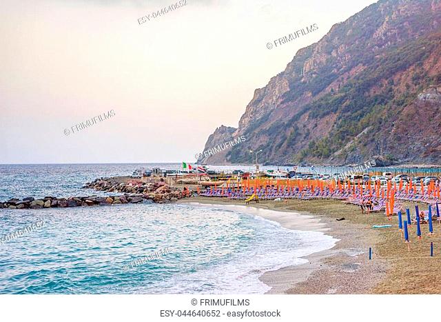 Sunset view to blue water and green mountains. Monterosso al Mare, Italy. Cinque Terre beauties