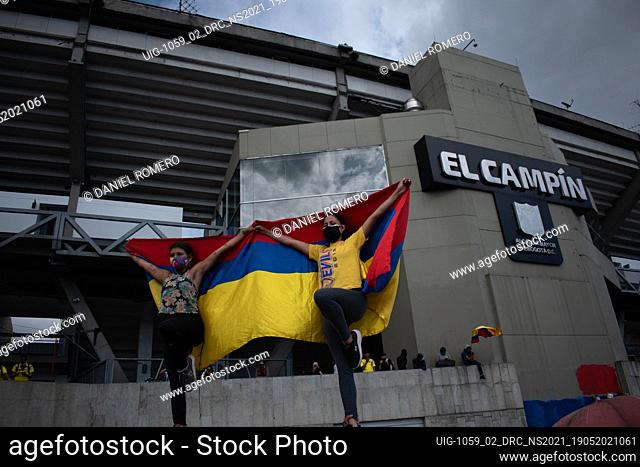 Protester carries the Colombian flag on his back as the demonstrations increase in Bogota on May 20, 2021 in the context of a national strike in Colombia...