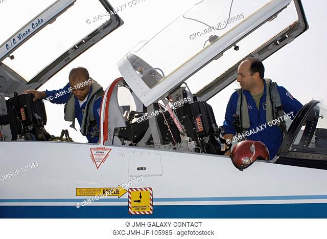 Astronauts Mark L. Polansky (right), STS-116 commander, and Robert L. Curbeam, mission specialist, go through a pre-flight check of the systems of a NASA T-38...