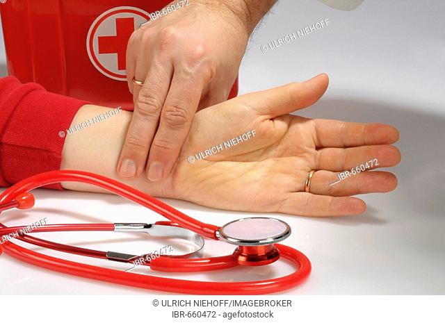 Doctor checking a patient's pulse