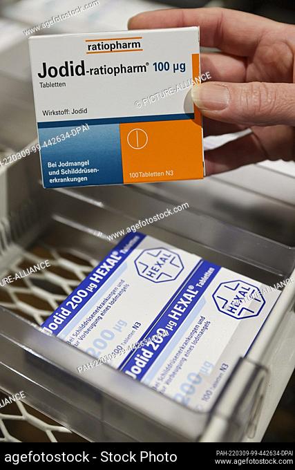 08 March 2022, Saxony, Leipzig: A pharmacist takes a pack of iodine tablets from a supply cabinet. The increased demand for iodine tablets in view of the war in...