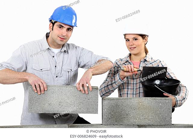 Man and woman building a house
