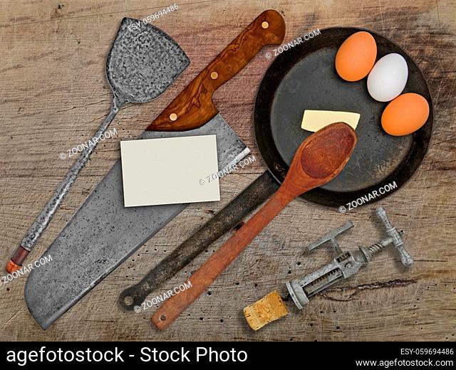 vintage set for frying eggs over wooden table, space on business card for your text